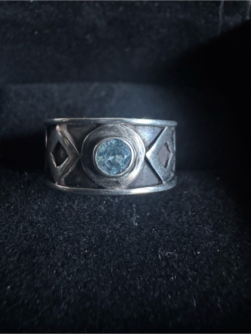 Wide band ring, oxidized geometric pattern/central round blue stone see below